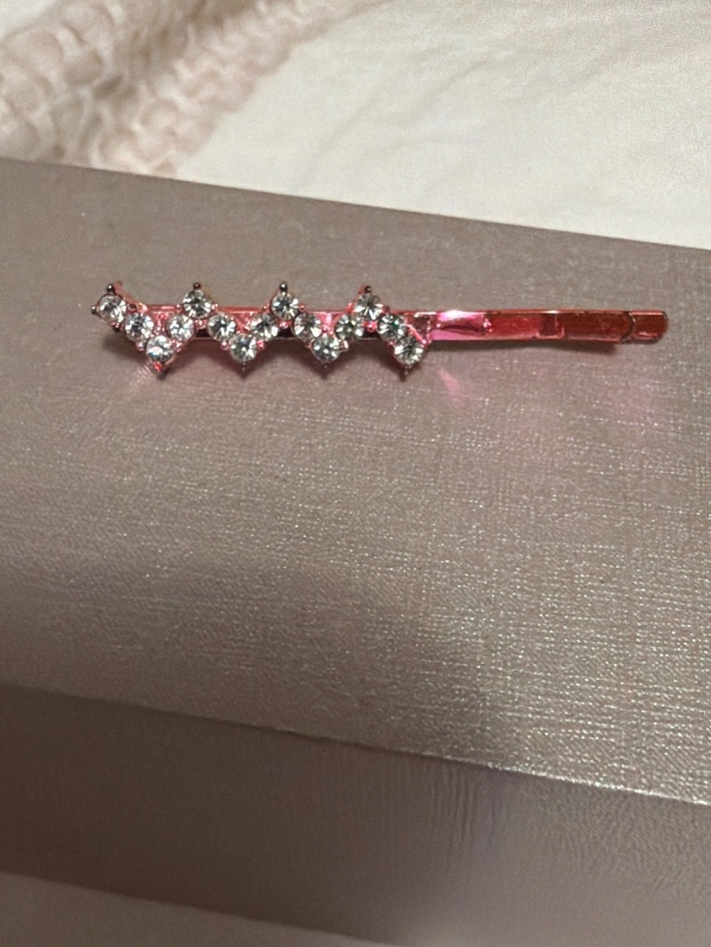 Small pink metallic bobby pin with rhinestone zig zag